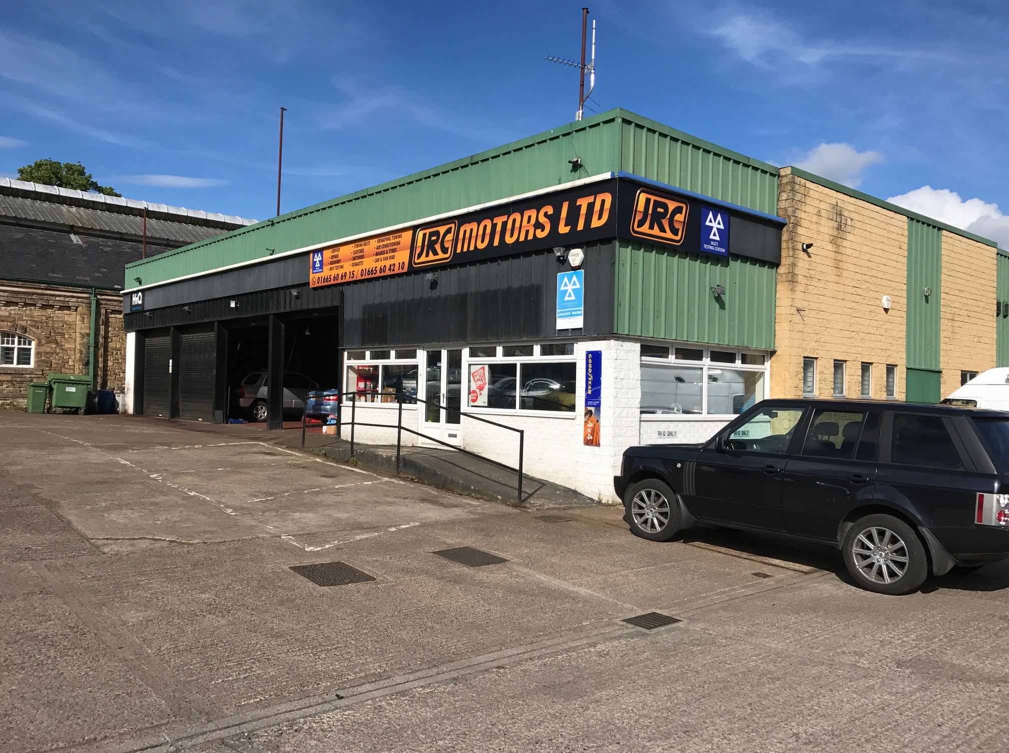 The JRC Motors Ltd workshop at Station Yard, Alnwick, with the JRC sign over the doors