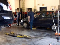 Inside the JRC Motors workshop, cars up on the ramps